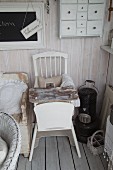 Vintage wooden board on white-painted wooden chair