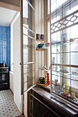 Old double windows with integrated glass shelves decorated with toys and collectors' items