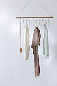 Clothes rail made from broom handle and wire coat hangers