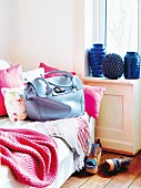 Blue Georgia business bag by Sonja Schweizer on sofa with pink blanket and scatter cushions