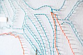 Stylised string-art map on white wall (detail)
