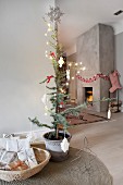 Simple Scandinavian interior with fireplace in concrete chimney breast and Christmas decorations