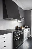 Elegant kitchen counter with extractor hood on grey wall