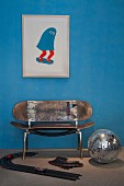 Upcycling - bench made from skateboards below modern picture of skateboard on blue wall