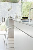 Elegant white kitchen island with bar stools