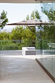 Terrace with glass balustrade and view of landscape