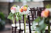 Chairs decorated with flowers for wedding