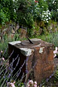 Metal sundial on top of stone block in garden