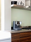 Espresso machine on kitchen counter with wood-effect base units