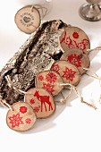 Garland of wooden discs stamped with red festive motifs