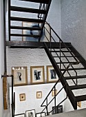 Metal staircase in stairwell with whitewashed brick walls
