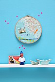 Souvenirs: maps in embroidery hoop decorating wall