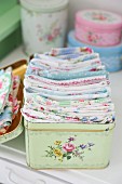 Vintage tin with floral pattern for storing scraps of pastel fabrics