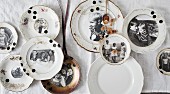 Vintage family photos on old gold-rimmed plates decorating wall