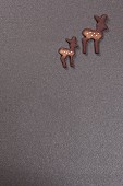 Two deer-shaped biscuits on grey surface