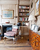 Reading area with fireplace in wood-panelled study