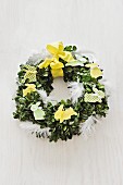 Easter floral wreath decorated with bunnies & feathers