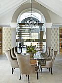 Dining area with chandelier, vaulted ceiling and upholstered chairs
