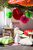 Terrace with party decorations, cushions and tray table