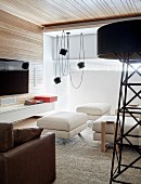 Large standard lamp and wood panelling in modern living room