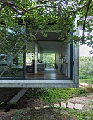 Cubic, concrete house with sliding glass walls