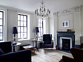 Open fireplace and lattice windows in classic living room