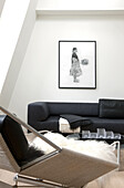 Fur blanket on armchair and black sofa in modern living room