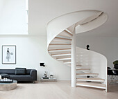 White spiral staircase in modern monochrome interior