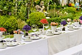 Long table set for afternoon coffee with posies of lavender and other flowers