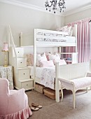 Antique furniture upholstered in delicate pink and storage stairs leading to bunk beds in romantic girls' bedroom