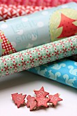 Rolls of various wrapping papers and pegs with numbers for DIY Advent calender