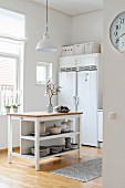 Island counter and side-by-side fridge-freezer in bright kitchen