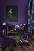 Scatter cushions on antique wooden bench, retro lamp on side table and oil painting of woman on wall painted aubergine