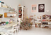 White, Scandinavian-style furniture and decorated Christmas tree on white-painted wooden floor in teenager's bedroom