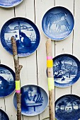 Blue, vintage decorative wall plates on white board wall