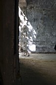 Pattern of light and shade on grey concrete wall of empty room