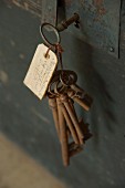 Rusty keys on vintage key ring with labelled tag