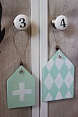 Shabby chic pendants with diamond and cross motifs hung from furniture knobs