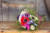 Bouquet of anemones and bilberry stems