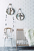 Round hanging shelves over baby bed, chair with color dipping