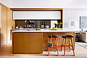 Modern fitted kitchen with light wooden fronts and kitchen island