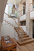 Elegant country-house-style stairwell with exposed brick walls and gallery