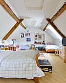 Three beds in converted attic bedroom with exposed wooden beams