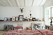 Collection of pictures on narrow wall-mounted shelf
