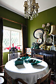 Moss-green walls in old-fashioned dining room