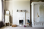 Classic furniture in niches flanking chimney breast