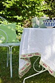 Tablecloth with hand-stitched trim on garden table