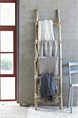 DIY, ladder-style towel rail made from rough branches
