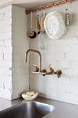 Sink with copper tap fitting and hook rail