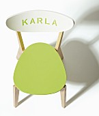 Wooden chair revamped with green-painted seat and lettering